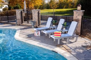 Three poly chaise lounges with adjustable backs and two poly side tables