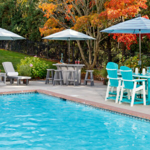 Poly poolside furniture including two chaise lounges with side tables