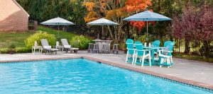 Poly poolside furniture including two chaise lounges with side tables