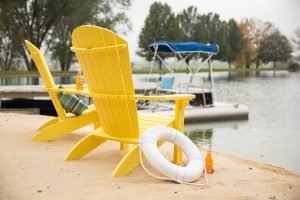 Two Yellow Poly Adirondacks on a dock