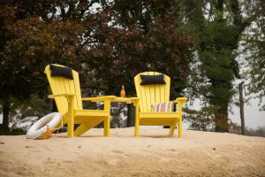 Two Yellow Poly Adirondack Chairs