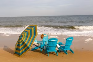 Teal Blue Poly Adirondack Chairs with Sunbrella Umbrella at the beach