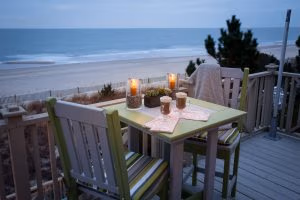 Square poly table with two chairs overlooking beach