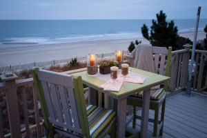 Square poly table with two chairs overlooking beach