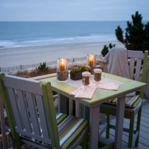 Square poly table with two chairs overlooking beach