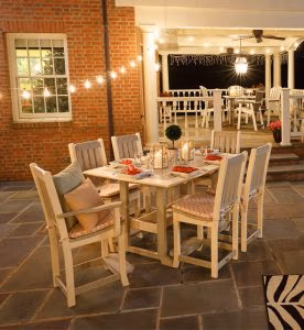 Rectangular poly dining table with four poly side chairs and two poly arm chairs