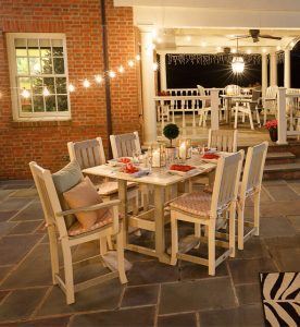 Rectangular poly dining table with four poly side chairs and two poly arm chairs