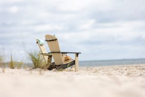 Poly Adirondack Chairs sitting in the sand on the beach