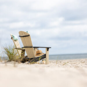 Poly Adirondack Chairs sitting in the sand on the beach
