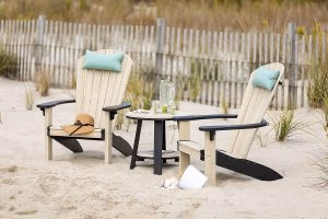 Poly Adirondack Chairs and Poly Table sitting in the sand on the beach