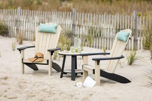 Poly Adirondack Chairs and Poly Table sitting in the sand on the beach