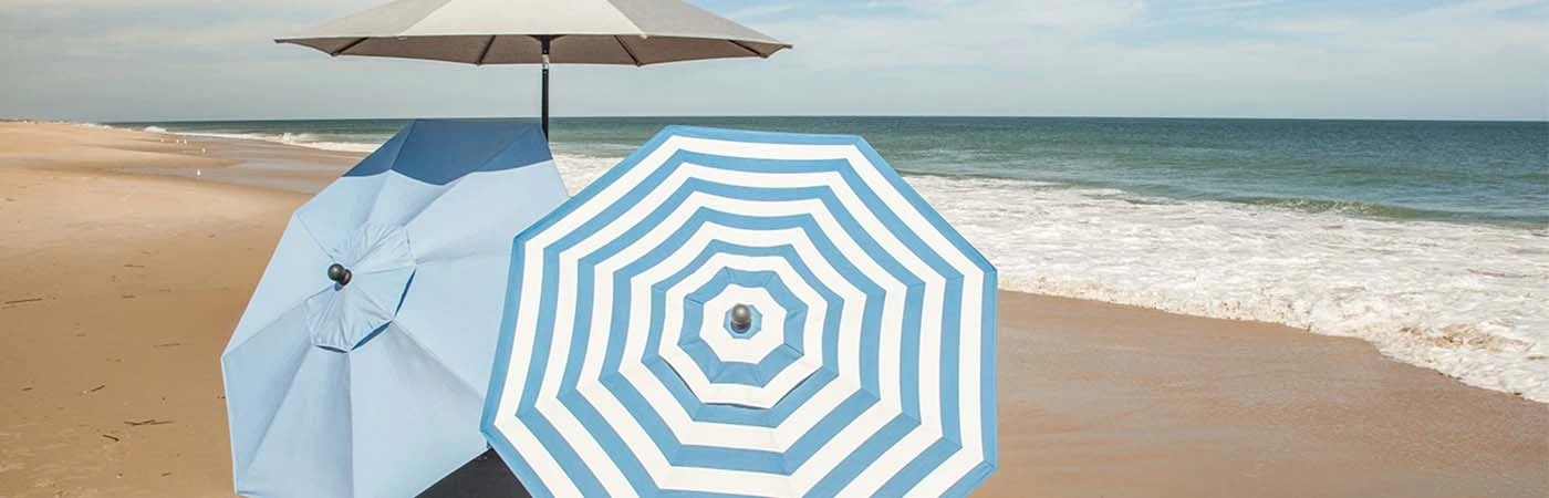 3 umbrellas set up on the beach