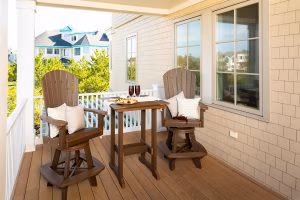 Bar Height Poly table flanked by 2 bar height fan back swivel chairs