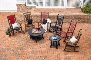 Poly porch rocking chairs on an outdoor paved patio.
