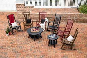 Poly porch rocking chairs on an outdoor paved patio.