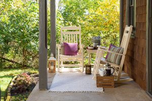 Two poly porch rockers on a porch with a Zinn's Mill Side Table