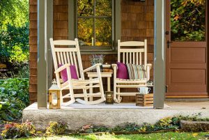 Two poly porch rockers on a porch with a Zinn's Mill Side Table