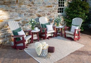 poly outdoor glider rockers and side tables on a patio