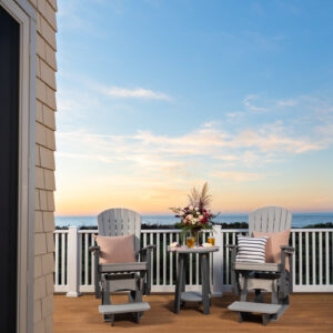 Poly Adirondack chairs and table on patio overlooking ocean.