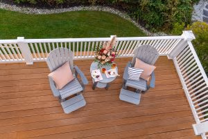 An aerial perspective of Poly Adirondack chairs and table on a patio.