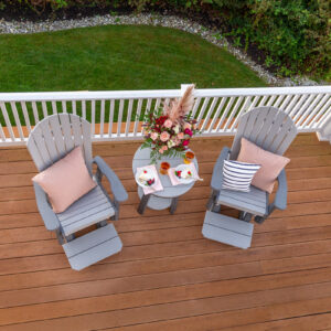 An aerial perspective of Poly Adirondack chairs and table on a patio.