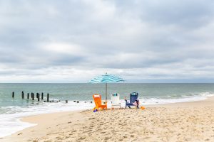 Blue outdoor umbrella with poly furniture chair set