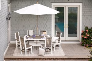 White outdoor umbrella with poly furniture chair set