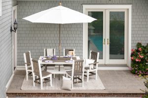 White outdoor umbrella with poly furniture chair set
