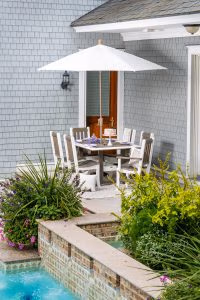 White outdoor umbrella with poly furniture chair set