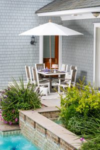 White outdoor umbrella with poly furniture chair set