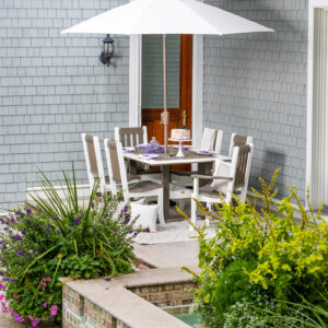 White outdoor umbrella with poly furniture chair set