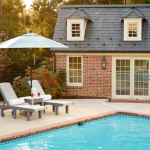 Poly poolside lounge chairs with side table and outdoor umbrella
