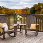 Two rockers sitting on a deck with autumn colors in the background.