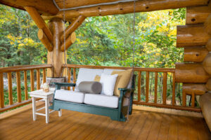 Vanu Buren Swing hanging on porch of log cabin in the woods