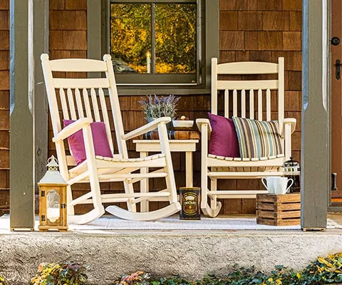 two zinn's mill finch rockers on a front porch of a cedar shake siding house