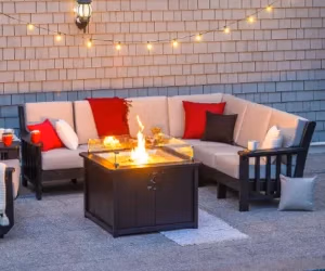 Deep seating set up around a fire pit in the evening light.