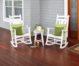 Two white rockers sitting on a front porch.