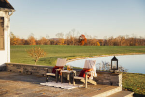 skyward poly patio furniture side patio seating stone wall and house corner