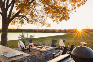 skyward poly patio furniture sunset sunburst over lake firepit view